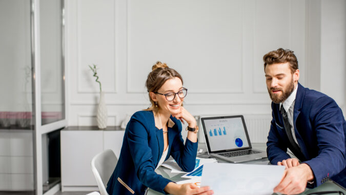 One woman and one man discuss on investments